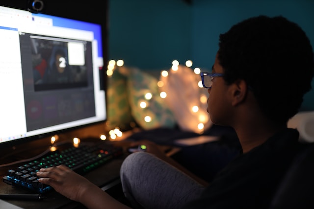 A young boy playing games on a desktop pc